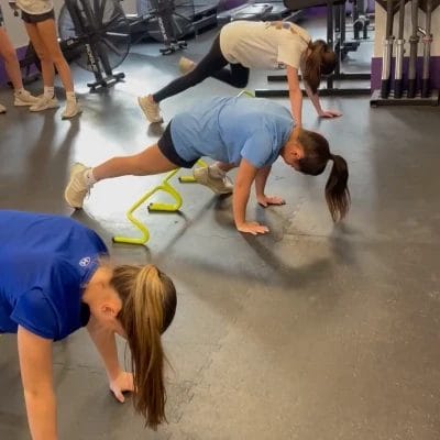 Group of young athletes doing conditioning exercises on the gym floor during a training session at Team Moljo Strength and Conditioning